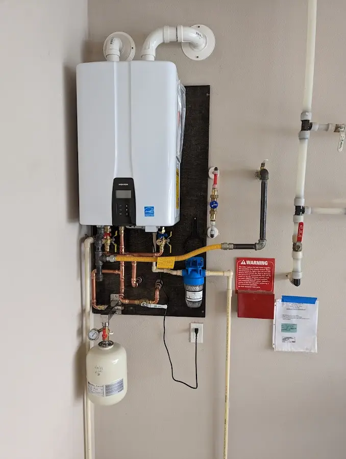 Professional plumber installing copper piping in a Morrilton home